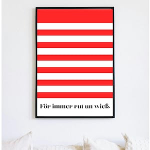 May include: Framed art print with a bold design of alternating red and white horizontal stripes. The artwork features the phrase "För immer rut un wieß" in black text at the bottom. The print is displayed on a white wall.