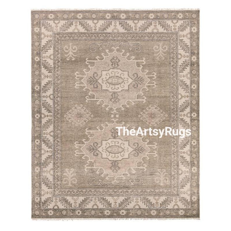 May include: A rectangular area rug with a central medallion design in shades of gray and beige. The rug features an intricate border and a repeating pattern. The text "TheArtsyRugs" is visible on the rug.
