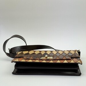 May include: A brown leather shoulder bag with a geometric pattern on the flap. The bag has a dark brown strap and a gold-colored clasp. The body of the bag is a solid dark brown.