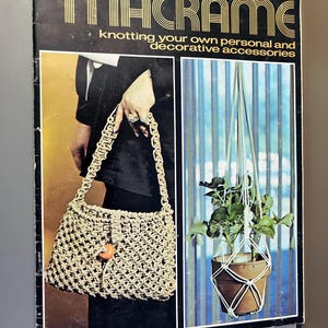 May include: A vintage magazine cover with the word "MACRAME" in gold lettering. The cover features a macrame handbag and a hanging plant holder. The text reads "knotting your own personal and decorative accessories."