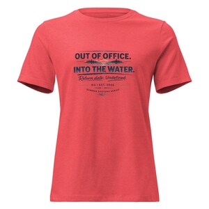 May include: Red t-shirt with the text "OUT OF OFFICE. INTO THE WATER." in navy blue. The shirt also includes the text "Return date: Undefined." and "RC-EST. 2026 SUMMER SYSTEMS SERIES."