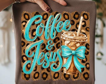 May include: A brown t-shirt featuring a graphic print of a leopard print background with vertical brushstrokes. The text Coffee & Jesus is written in a bright turquoise script font. A brown iced coffee cup with a turquoise bow and straw is included.