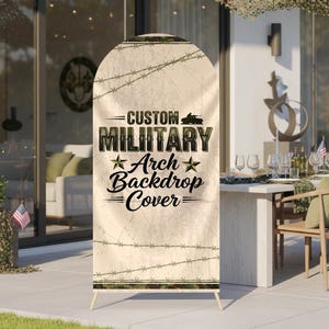 May include: A custom military arch backdrop cover with a camouflage and barbed wire design. The text reads "Custom Military Arch Backdrop Cover" in black and green. The backdrop is supported by a wooden stand.