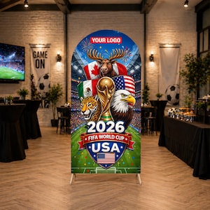 May include: A tall, vertical banner for the 2026 FIFA World Cup USA, featuring a golden trophy, flags of the USA, Canada, and Mexico, and an eagle and jaguar. The banner has the text "2026 FIFA WORLD CUP USA" and a space for a logo.