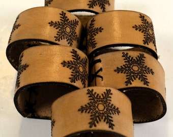 Handmade set of six leather napkin rings with snowflake designs