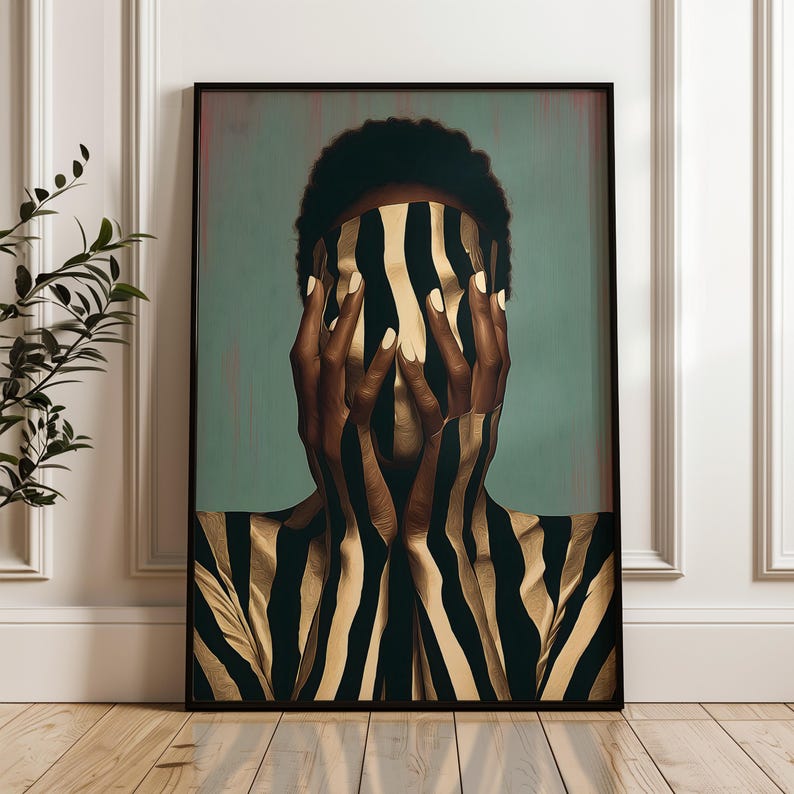 May include: A framed wall art print featuring a person with dark skin and short hair, their face obscured by hands. The figure is covered in a vertical pattern of black and gold stripes against a muted teal background, creating a striking contrast.