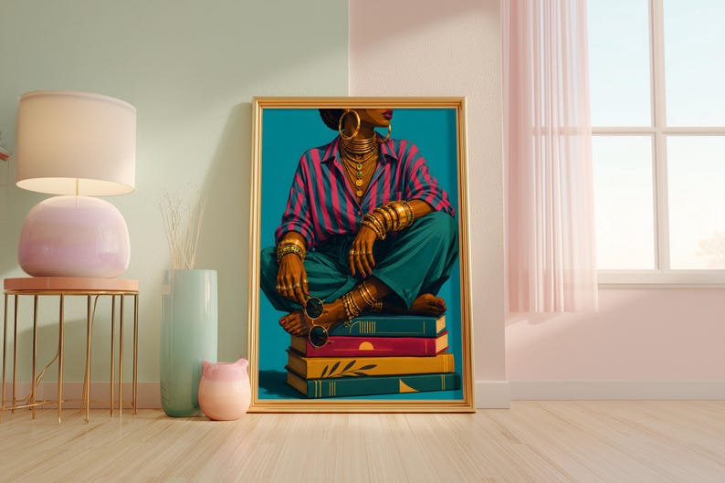 May include: A framed art print featuring a person wearing a pink and blue striped shirt and teal trousers, adorned with gold hoop earrings, layered necklaces, and multiple gold bracelets, sitting cross-legged on a stack of four colorful books.