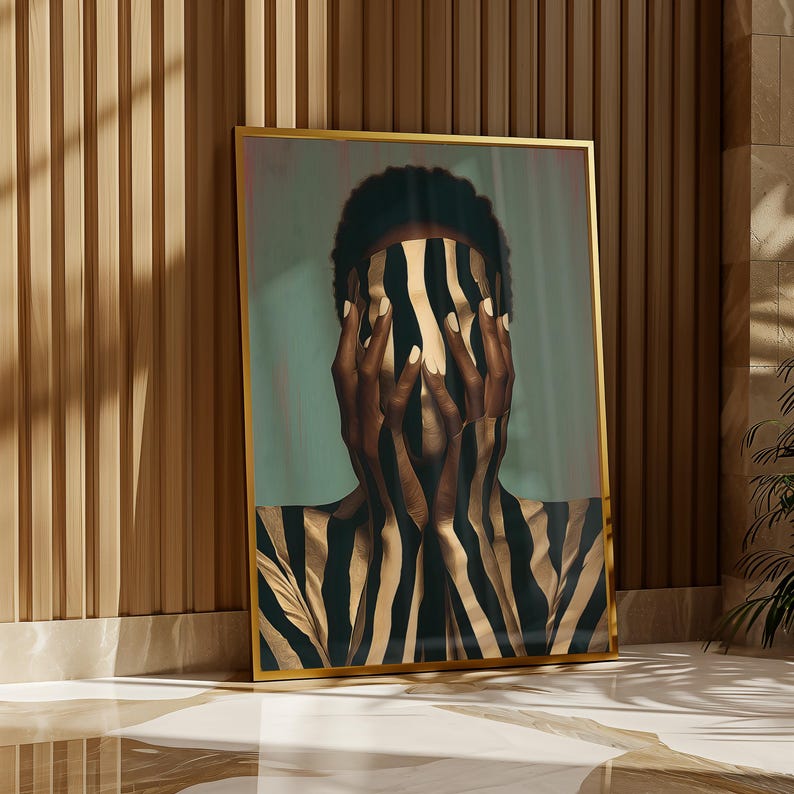 May include: A framed vertical wall art print featuring a person with dark skin covering their face with hands, both adorned with a bold black and gold vertical striped pattern that extends across the torso, set against a muted teal background.