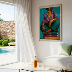 May include: A framed wall art print featuring a person wearing a pink and blue striped button-down shirt, teal trousers, and multiple gold bracelets and necklaces. The person sits atop a stack of three books in teal, magenta, and yellow colors.