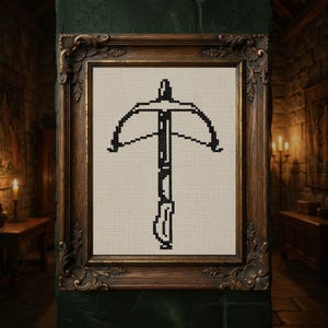 May include: A framed cross-stitch artwork featuring a black crossbow design. The artwork is set against a beige fabric background and enclosed in a decorative, ornate brown wooden frame. The piece is displayed in a dimly lit room.