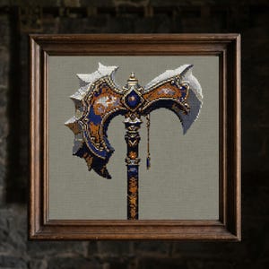 May include: Framed cross-stitch art featuring a detailed fantasy axe. The axe head is silver and blue, with gold and orange accents. The handle is dark blue and gold. The artwork is displayed in a brown wooden frame.