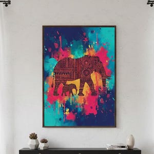 May include: A framed art print featuring a silhouette of an elephant with intricate patterns, set against a vibrant background of blue, pink, and yellow paint splatters. The artwork is displayed above a black console table.