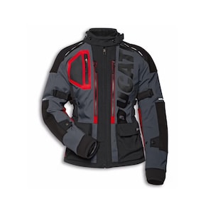 May include: A motorcycle jacket in grey, black, and red. The jacket features the word "DUCATI" in large letters on the chest. It has multiple pockets, zippers, and reinforced panels for protection. The jacket has a high collar and is designed for riding.