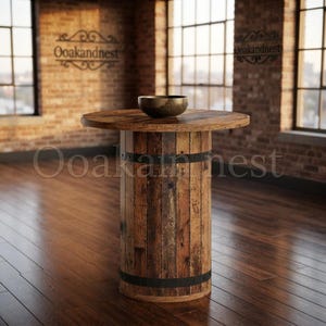 May include: A tall, cylindrical table constructed from vertical wooden planks with dark metal bands encircling the top and bottom. The table features a circular wooden top surface and is topped with a single, dark, shallow bowl.