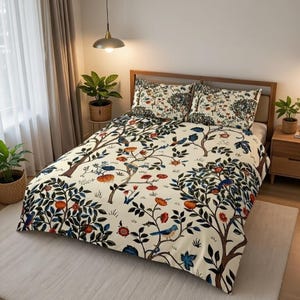 May include: A cream-colored duvet cover and two pillowcases feature a tree and bird design. The branches are brown, with blue, orange, and red flowers and birds. The bedding set is on a wooden bed frame.