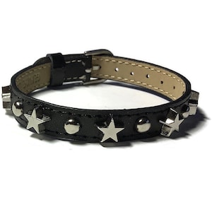 May include: Black leather bracelet with silver star accents and studs.