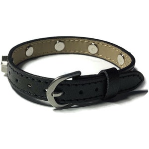 May include: A black leather bracelet with a silver buckle and silver studs. The bracelet is about 7 inches long.