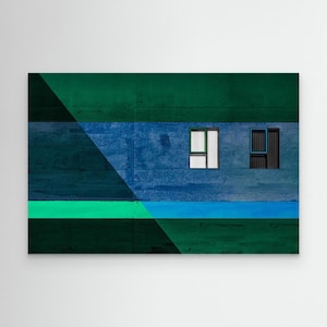 May include: Abstract architectural art print with a geometric design in shades of green and blue. The artwork features two rectangular windows, one with white vertical lines and the other with a blue frame, against a textured wall.