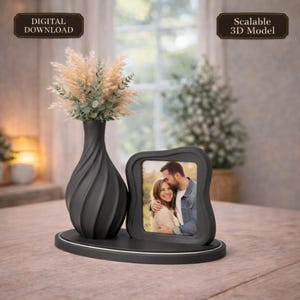 May include: A black decorative set comprising a vase with dried flowers and a photo frame displaying a couple's image. The vase has a spiral design. The set sits on a black oval base with silver trim. The image includes the text "DIGITAL DOWNLOAD" and "Scalable 3D Model".
