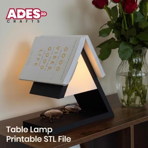 May include: A black and white table lamp with a book-shaped design. The lamp has a built-in light and is paired with a pair of eyeglasses. The text "GOOD VIBES, GOOD LIFE" is visible on the book. The lamp is labeled "Table Lamp Printable STL File".
