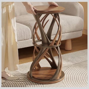 May include: A round side table featuring a dark wood top and base connected by a sculptural frame of intertwined, curved dark brown metal and wood elements. The structure includes a central circular ring support and a smooth, polished finish.