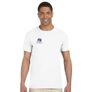 May include: White t-shirt with a small graphic on the left chest. The graphic features a blue and white design with text below it. The shirt is short-sleeved and has a crew neck.