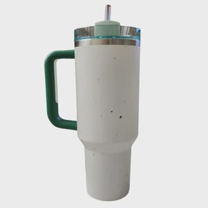 May include: A white insulated travel mug with a green handle and lid. The mug has a stainless steel rim and a clear lid with a green top and a straw. The mug is approximately 23 cm tall.