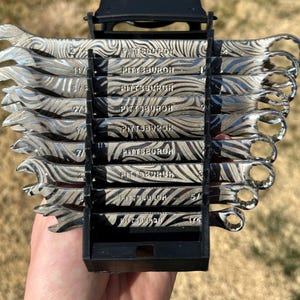 May include: A set of silver wrenches with a unique patterned design, held in a black organizer. Each wrench is labeled with a size, and the word "PITTSBURGH" is printed on each wrench.