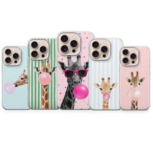 May include: A collection of five phone cases featuring giraffe illustrations. Each case has a different background color and design, including stripes and polka dots. The giraffes are depicted blowing bubblegum bubbles, with one wearing sunglasses.