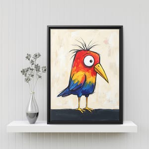 May include: A framed wall art print featuring a stylized bird with a bright red, orange, and yellow head, a large white eye, a yellow beak, and blue wings. The bird stands on a dark horizontal line against a light, textured cream background.
