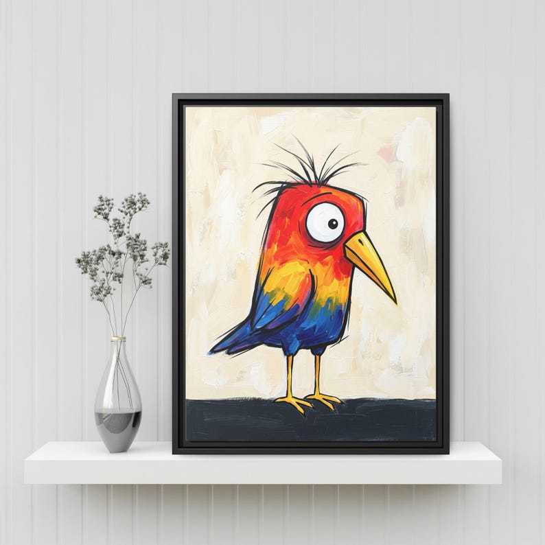 May include: A framed wall art print featuring a stylized bird with a bright red, orange, and yellow head, a large white eye, a yellow beak, and blue wings. The bird stands on a dark horizontal line against a light, textured cream background.