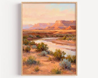 May include: A framed landscape painting depicting a desert scene with a winding river flowing through arid terrain. The composition features mesas in the background under a soft, warm sky, with sage-colored desert shrubs in the foreground.