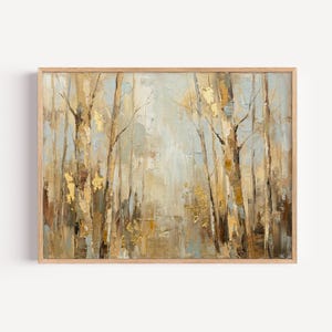 May include: An abstract landscape painting of a forest scene. The artwork features tall, slender trees with gold accents against a backdrop of muted blues and browns. The painting is framed in a light-colored wooden frame.