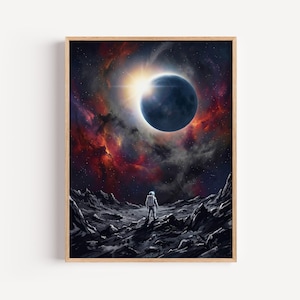 May include: A framed art print depicts an astronaut standing on a rocky surface, gazing at a celestial event. The artwork features a dark blue planet, a bright sun, and a vibrant nebula in shades of red, orange, and purple.