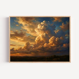 May include: A framed landscape painting depicting a dramatic sunset sky filled with large, billowing cumulus clouds illuminated in shades of gold, orange, and deep blue, hovering above a dark, silhouetted horizon line of distant rolling hills.