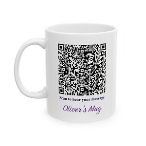 May include: White ceramic mug with a black QR code and the text "Scan to hear your message" and "Oliver's Mug" in purple. The mug has a curved handle.