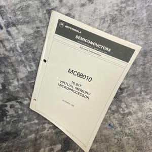 May include: A white Motorola Semiconductors technical manual for the MC68010 16-bit virtual memory microprocessor. The cover features the Motorola logo, the address in Austin, Texas, the text Advance Information, and the date December, 1982.