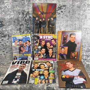 May include: A collection of magazines and a yearbook featuring the boy band *NSYNC. The magazines include *Teen People*, *Vibe*, and *Superteen*, with images of the band members and Justin Timberlake. The yearbook has a gold and red cover.