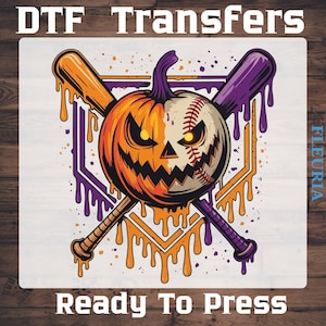 May include: A DTF transfer sheet featuring a graphic of a pumpkin-baseball hybrid with a jagged face, crossed by an orange and a purple baseball bat. The design includes dripping paint effects in orange and purple, with the text DTF Transfers and Ready To Press.