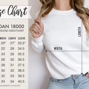The image is a size chart for a GILDA 18000 heavy blend sweatshirt. It shows the measurements for different sizes, including S, M, L, XL, XXL, and 5XL. The chart also includes a diagram with a line indicating the width of the sweatshirt.