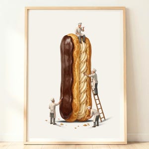 May include: A framed art print featuring a large chocolate eclair standing vertically. Four miniature figures dressed as chefs in white uniforms and hats are interacting with the pastry, using tools to apply chocolate glaze and cream filling.