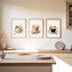 May include: A set of three framed wall art prints featuring miniature figures working on large coffee cups. Each print displays a different style of coffee, including latte art and espresso, with tiny ladders and tools resting against the mugs.