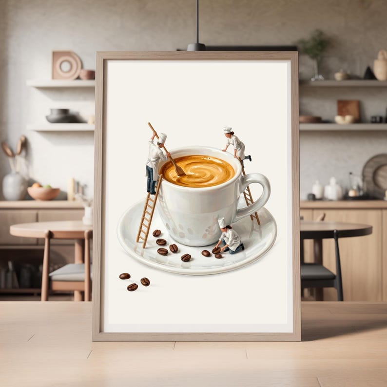 May include: A framed wall art print featuring a white ceramic coffee cup on a saucer filled with latte art. Three miniature figures dressed as chefs in white uniforms and hats are interacting with the cup, using wooden ladders and spoons.