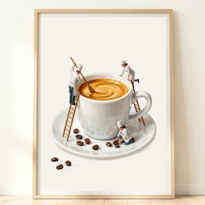 Espresso Wall art print featuring a white ceramic coffee cup and saucer filled with light brown coffee. Three miniature figures dressed as chefs in white uniforms are interacting with the cup, using wooden ladders and a spoon.