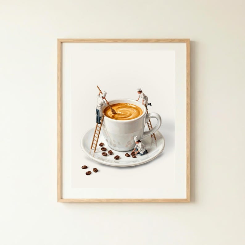 May include: A framed print depicts a whimsical scene of miniature chefs preparing coffee in an oversized white mug. The coffee is swirled, and the cup sits on a saucer with scattered coffee beans. The chefs use ladders and spoons.