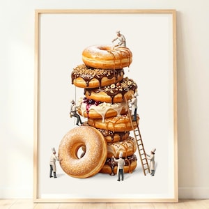 May include: A framed art print featuring a vertical stack of glazed and frosted doughnuts. Miniature figures dressed as chefs in white uniforms are shown interacting with the doughnuts, using ladders and ropes to decorate the pastry tower.