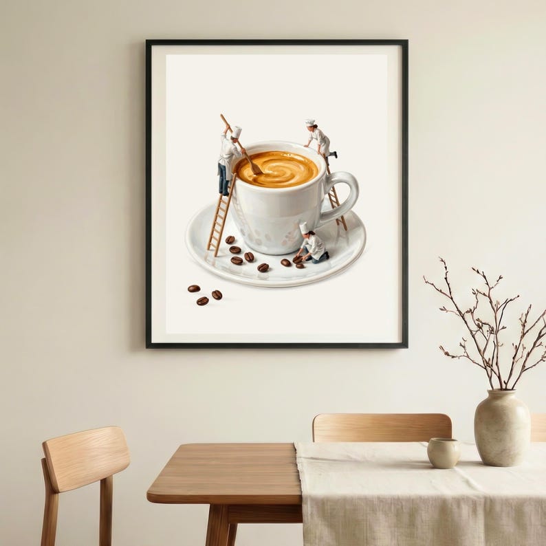 May include: A framed wall art print featuring a large white coffee cup on a saucer. Miniature figures dressed as chefs are climbing wooden ladders to stir the coffee and arrange dark brown coffee beans on the saucer and surrounding surface.