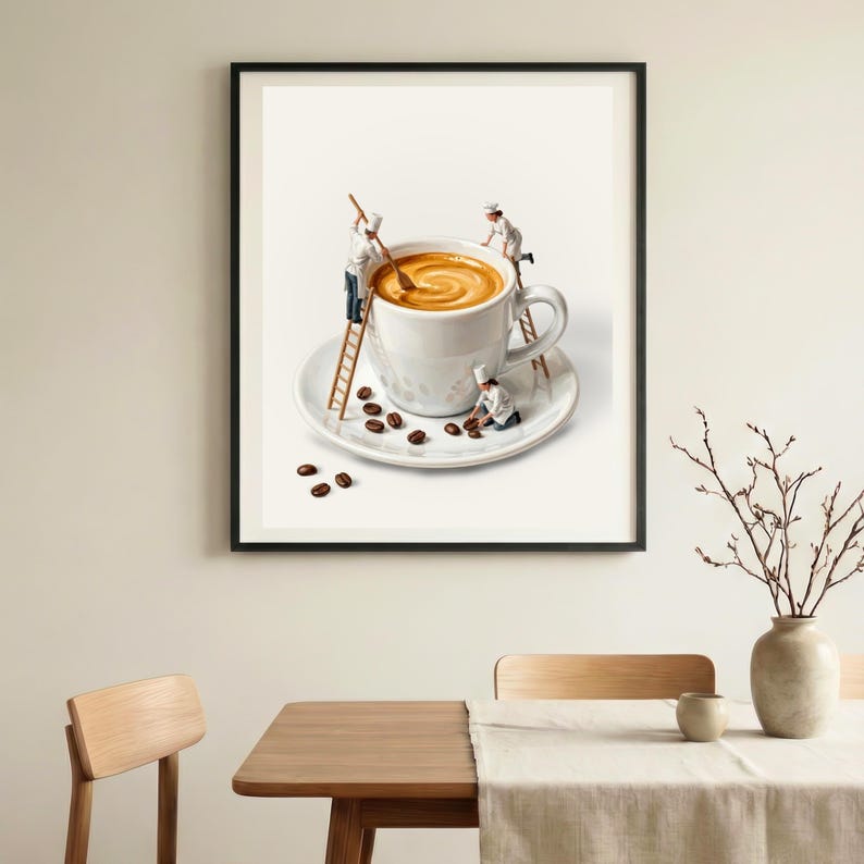 May include: A framed print depicts a whimsical scene of miniature chefs preparing coffee in an oversized white mug. The coffee is swirled, and coffee beans are scattered on the saucer. The print is displayed in a dining room setting.