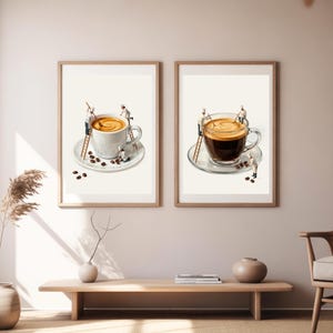 May include: Two framed wall art prints featuring miniature chefs working on coffee cups. The left print shows a white cup with latte, while the right print shows a clear glass cup with black coffee. Both feature tiny figures on ladders.