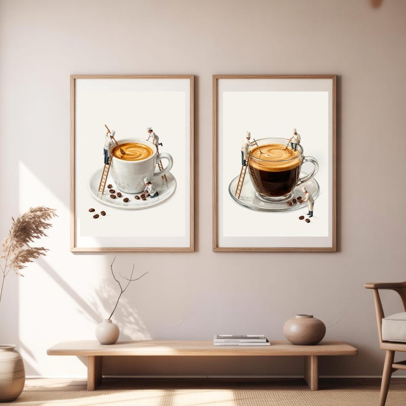 May include: Two framed wall art prints featuring miniature chefs working on coffee cups. The left print shows a white cup with latte, while the right print shows a clear glass cup with black coffee. Both feature tiny figures on ladders.
